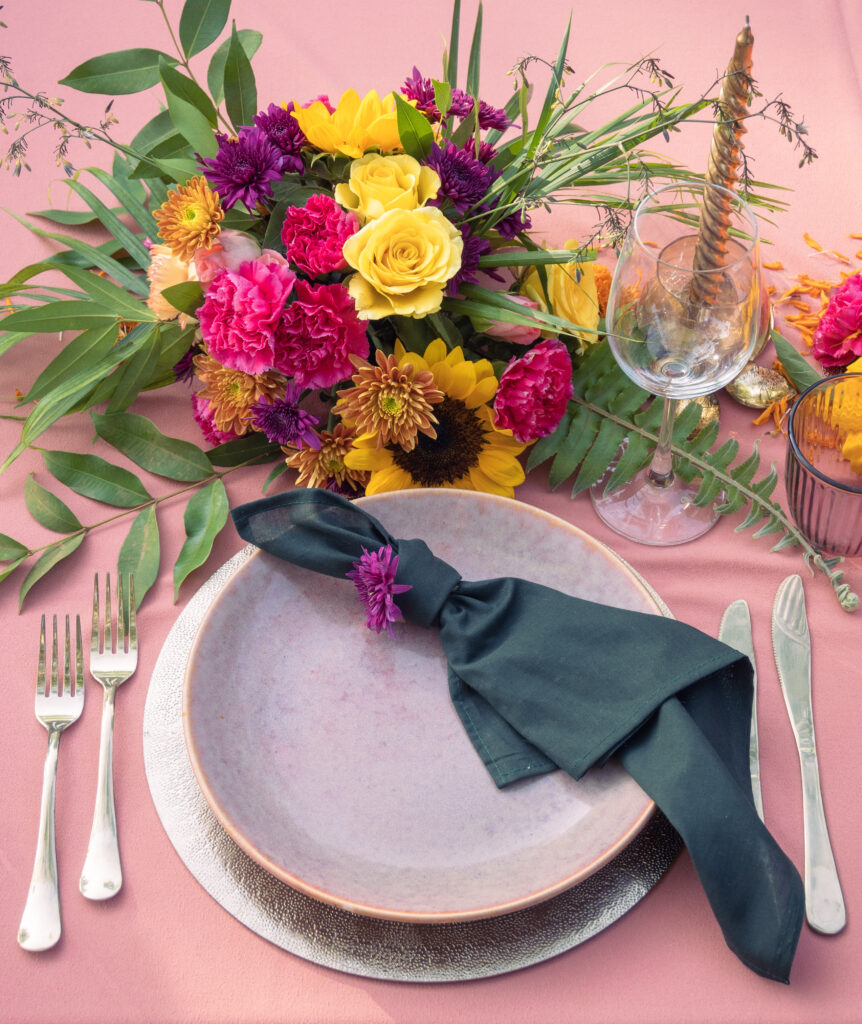 Bougainvillea Wedding Table Decor Setup at Kala Bahia Elegant bougainvillea-themed wedding table setup at Kala Bahia, a sea-facing wedding venue in South Goa, featuring floral arrangements and tropical decor.