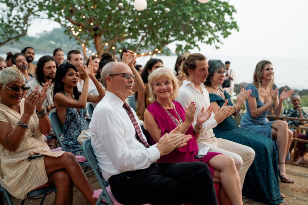 Guests Witnessing Vows at a Beachside Wedding in South Goa Wedding guests seated and watching the couple exchange vows at Kala Bahia, a scenic beachside wedding venue near Palolem Beach in South Goa.