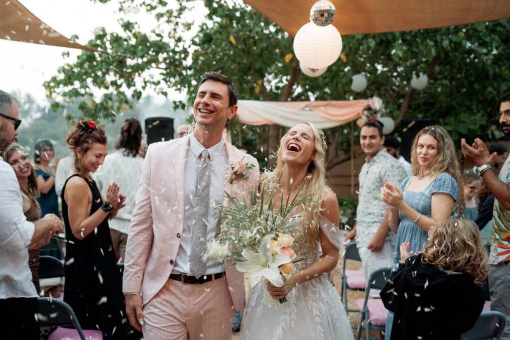 Amy & Andrey Walk Down the Aisle at Beachside Wedding Venue in South Goa Amy and Andrey walking down the aisle at Kala Bahia, a beachside wedding venue in Goa near Palolem Beach, as guests toss flower petals during their ceremony at a stunning South Goa wedding venue.