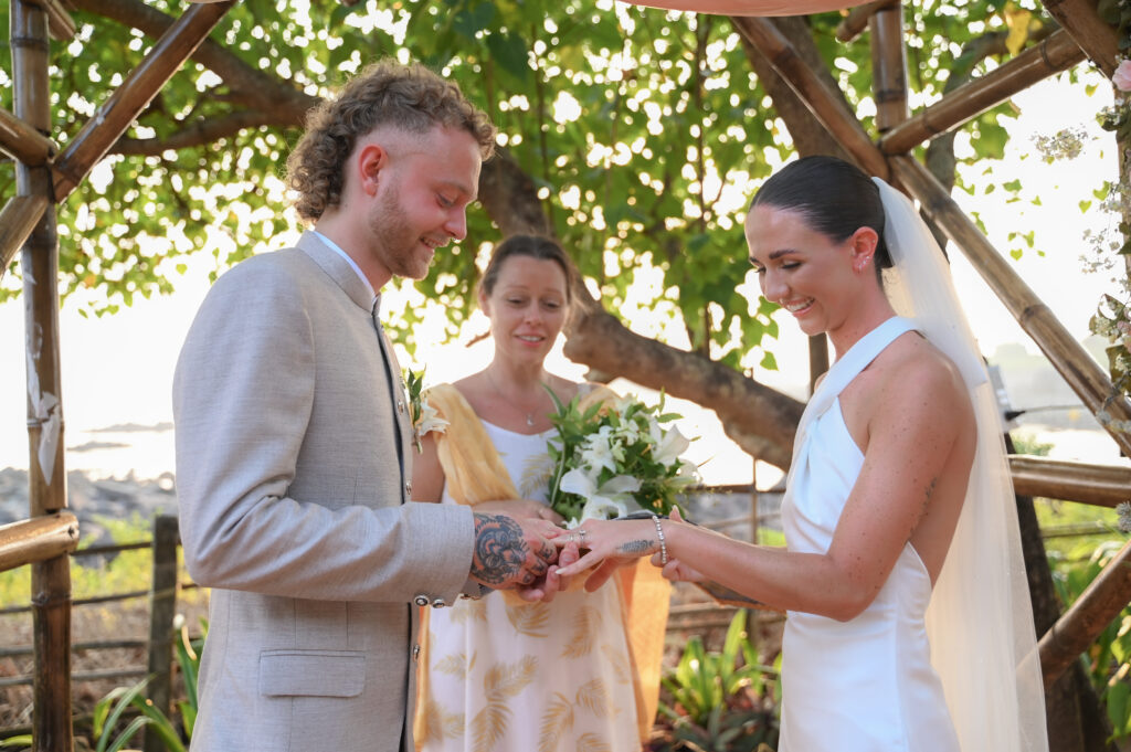 Rebecca & Regan Exchanging Rings at Kala Bahia Wedding Ceremony Bride and groom exchanging rings during their beachside wedding ceremony at Kala Bahia, a picturesque oceanfront wedding venue in South Goa near Palolem Beach.