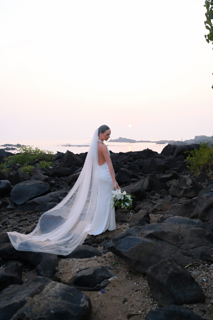 Rebecca’s Bridal Portrait during Sunset in South Goa Elegant bridal portrait of Rebecca in her wedding gown with a stunning sunset backdrop at Kala Bahia, a beachside wedding venue near Palolem Beach in South Goa.